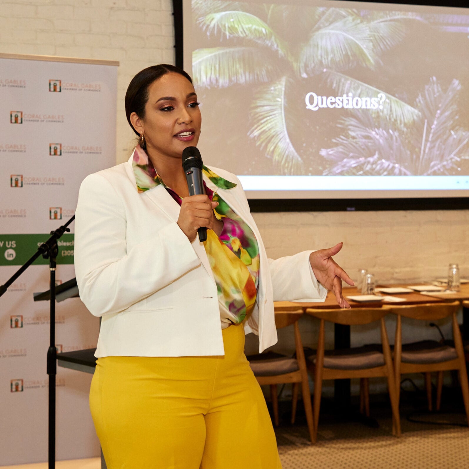Tamika speaking to a group with a hand-held mike
