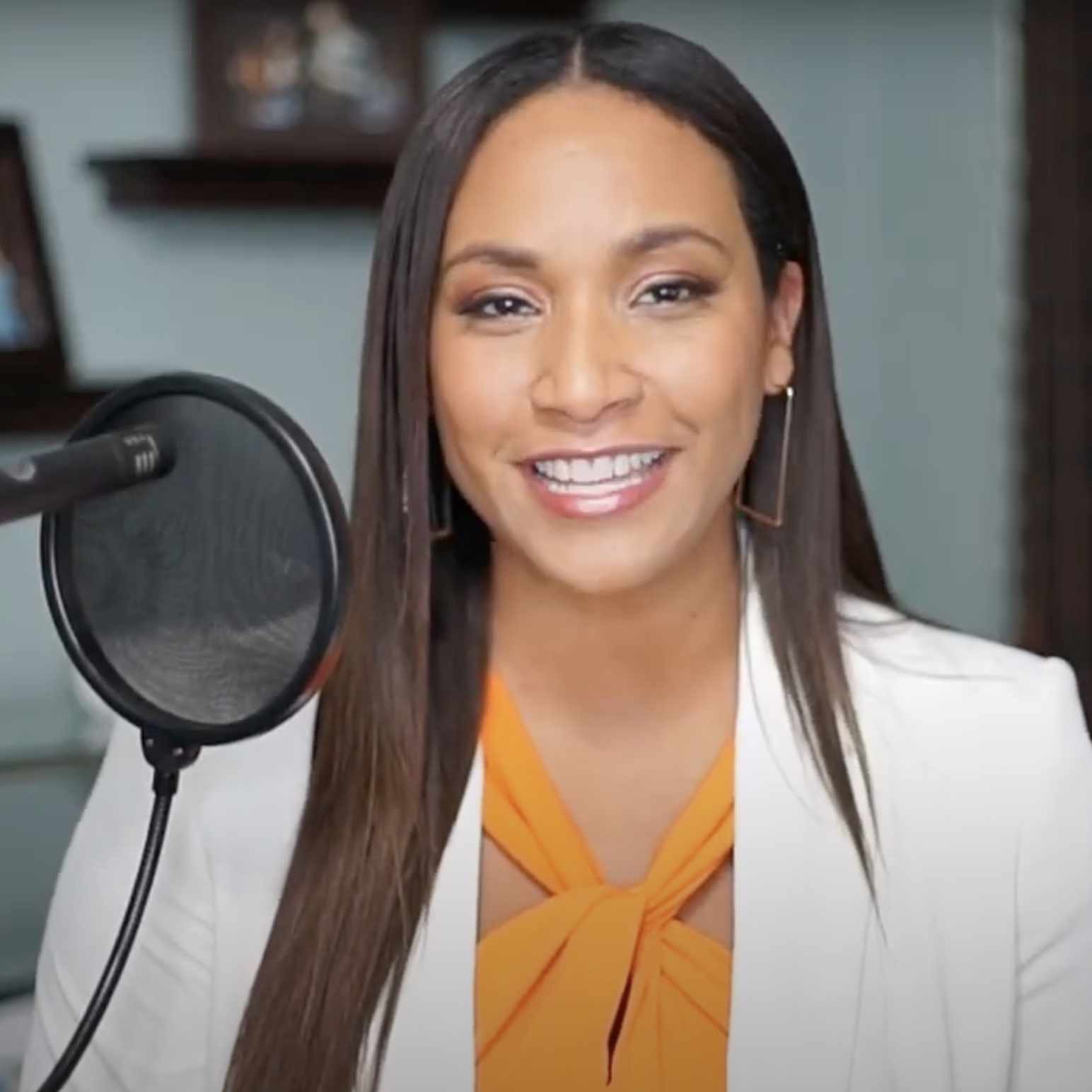 Tamika speaking into a microphone